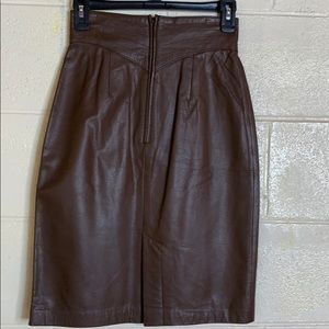 Coffee brown leather skirt very nice stitching around the waist , zip up back.